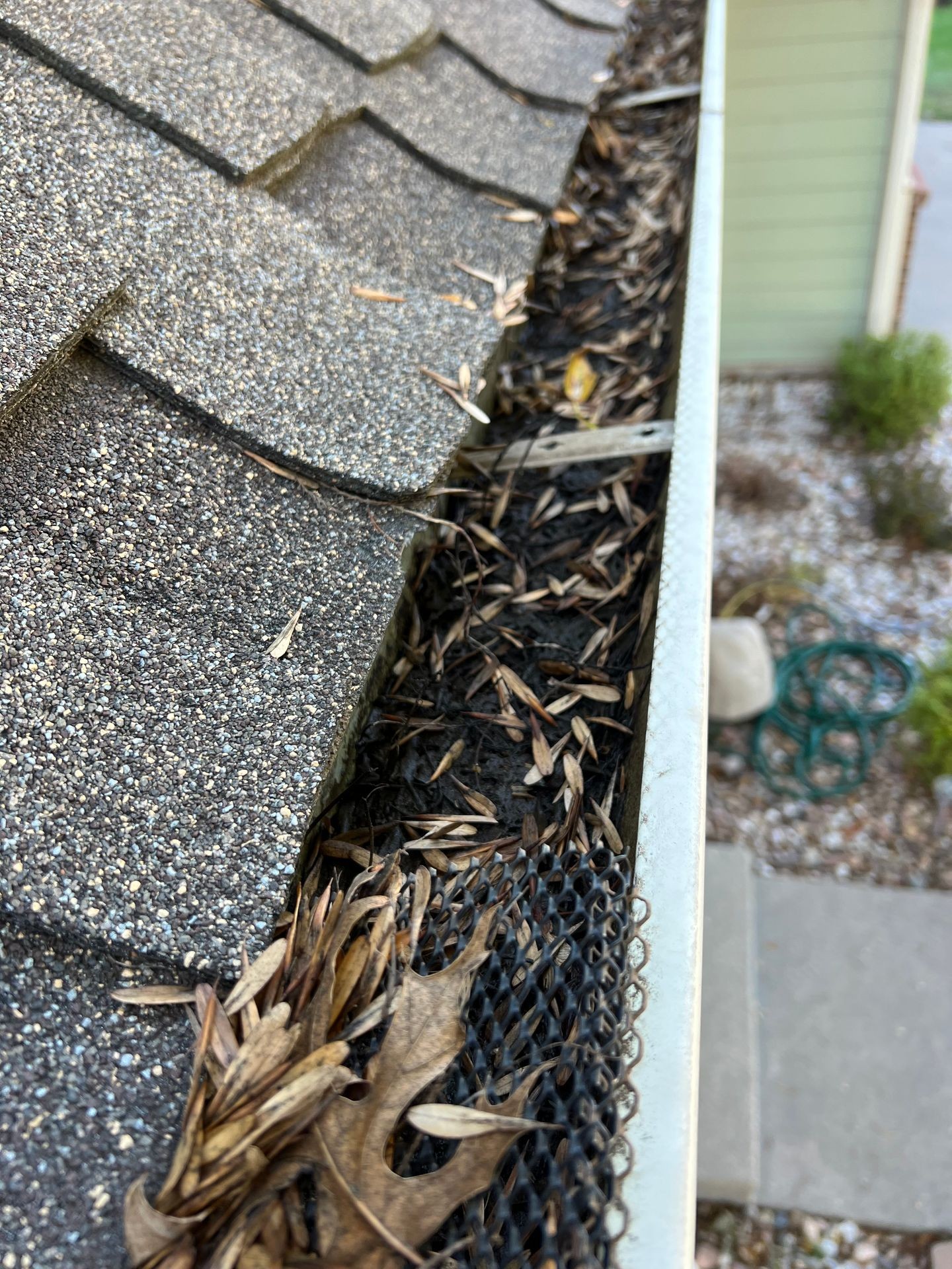 A gutter filled with dirty and leaves 