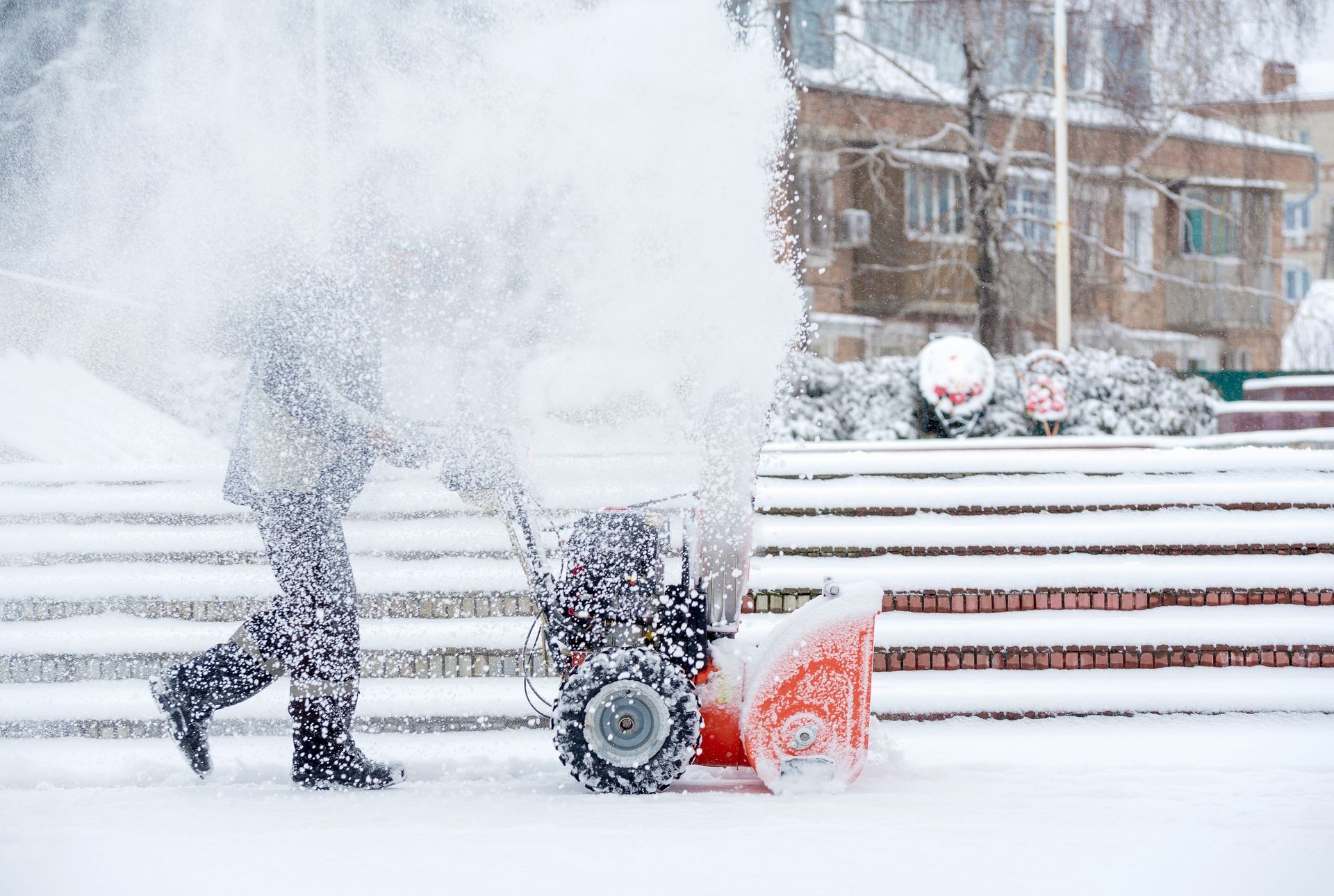 Snow-removal work with a snow blower. Man Removing Snow. heavy precipitation and snow piles